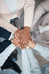 Image showing Hands, collaboration and solidarity with a team of business people standing in a huddle or circle in the office from above. Teamwork, motivation and unity with a man and woman employee group at work