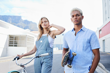 Image showing Couple, skateboard and bicycle in portrait for fashion, fun and ride in city during summer. Man, woman and bike outdoor together to skate, cycle and gen z on street with confidence in Cape Town