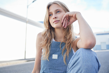 Image showing Woman, street and thinking of goal, dream or future with focus, idea and wonder on face in city. Student, creative or fashion for girl sitting in road for thought, sad and depression in her life