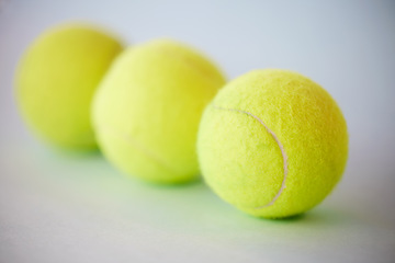 Image showing Sport, tennis ball and fitness background for training, exercise and competitive match. Green, equipment and balls for athlete health and hobby with still life equipment on the floor ready for a game