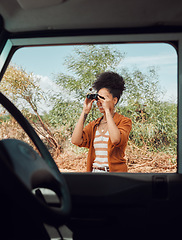 Image showing Road trip, travel and binoculars with a sightseeing woman outdoor in nature for a summer vacation or weekend getaway. Freedom, holiday and vehicle with a female standing by her car while traveling