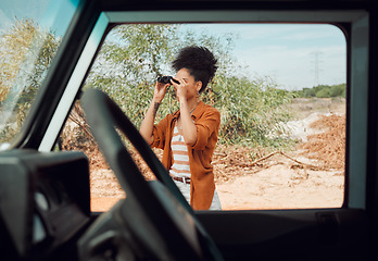 Image showing Black woman with binocular for view, travel and adventure on road trip in countryside desert. Transportation for safari, outdoor journey in nature and young person with traveling lifestyle.