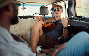 Image showing Man with guitar, music in van and smile on travel vacation road trip together with friends. Group holiday in summer, relax and happy musician singing with instrument on a countryside safari adventure