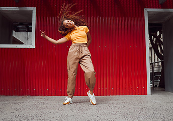 Image showing City, hip hop dance and an urban black woman in streetwear dancing outside in Sao Paulo. Music, dancer and a cool happy latino girl with outdoor street style, fun energy, freedom and youth in Brazil.