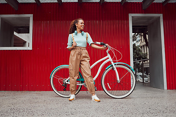 Image showing Bike, fashion and black woman cycling for sustainability, eco friendly and carbon footprint in the city of Norway. Happy, smile and relax African girl with bicycle to travel for sustainable lifestyle