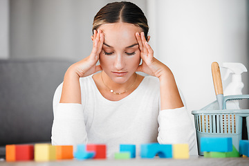 Image showing Stress, headache and cleaning with an upset woman or mother in her home to clean up kids toys. Tired, exhausted and overworked with a female parent in her house, stressed or annoyed about mess