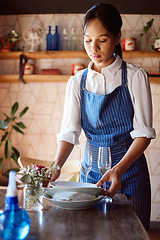 Image showing Waitress, restaurant and clean at table for plate, glass and cutlery in apron at work. Woman, cafe or coffee shop cleaning with hands after lunch, dinner or meal with customer dishes in Cape Town