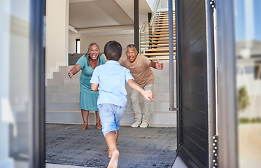 Image showing Excited kid running to grandparents in family home meeting, greeting and hugging with love, care and happiness. Elderly man, senior woman and happy people welcome grandson child at front door house