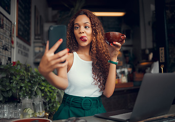 Image showing Selfie, coffee shop and funny with a woman customer using a laptop and phone in her local cafe. Silly, face and mobile with a young female posting a photograph on the internet while in a restaurant