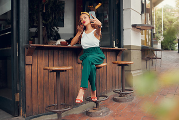 Image showing Restaurant, woman and influencer taking a phone selfie for social media content for online followers outdoors. Lifestyle, cafe and young person blowing a kiss on a photo enjoying summer holidays