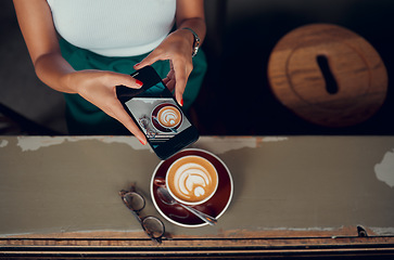 Image showing Phone, cappuccino and social media influencer at breakfast blogging or vlogging her food at a restaurant business. Content creator and social media post coffee, coffee shop and creative ideas in cafe