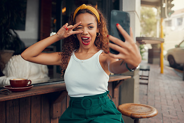 Image showing Coffee shop, selfie and black woman with peace hand sign on smartphone for social media post, internet marketing and gen z lifestyle. Cafe, restaurant and influencer customer with cellphone portrait