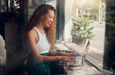 Image showing Coffee, laptop, and black woman typing an email while working at a coffee shop. Happy, smile and creative African freelancer networking on the internet and writing a proposal for work on tech at cafe