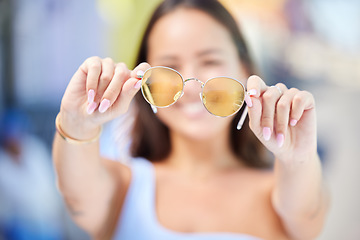 Image showing Summer, fashion and sunglasses in hands of woman for style and beauty. Sunshine, holiday and Asian woman with stylish accessories in the city to enjoy vacation, travel and adventure on a sunny day