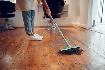 Image showing Hairdresser woman, sweeping hair and cleaning salon or barbershop wooden floor after cutting a hairstyle or doing a trim. Feet of female worker with broom for dirt, dust and mess for clean workplace