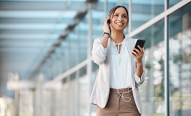 Image showing Business woman, phone and earphones in city on walk streaming music, podcast or radio. Break, relax and female from Canada on 5g mobile app listening to audio song, having fun and walking in town.