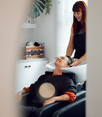 Image showing Hairdresser, woman client and hair care to relax and smile after washing in the basin. Salon, beauty spa and professional stylist with a female customer for hairstyle change, pamper and good service