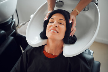 Image showing Woman, hairdresser and hair care being relax, with head dry with towel after wash in basin. Salon, beauty spa and professional stylist with senior client, for hairstyle change and happy with service