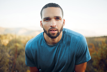 Image showing Fitness, running and man portrait with sweat face in forest for cardio exercise in Phoenix, USA. Runner workout with wet and tired guy taking a breath to rest and cool down in green woods.