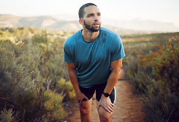 Image showing Tired runner, man running on nature park trail fitness training exercise and cardio health for a summer marathon. Sport athlete run workout, rest on natural road and train for sports race competition