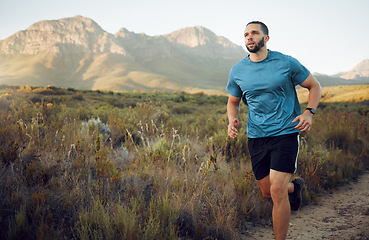 Image showing Fitness, mountain and man running in nature training for health, wellness and sports workout. Exercise, lifestyle and marathon with athlete runner for summer, freedom and stamina on grass field path