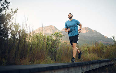 Image showing Runner, fitness and man in nature running for outdoor workout, healthy energy and wellness goal with sky mock up background. Sports person with exercise training motivation jogging near the mountains