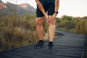 Image showing Knee pain, running and exercise in nature, man holding leg from sore joint or muscle. Training, fitness and runner exercising in woods or mountain trail with sports injury, athlete hurt after workout