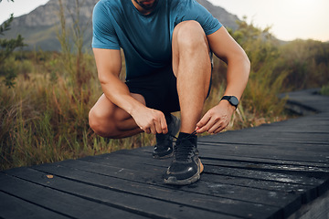 Image showing Hiking shoes lace, nature and man workout, running and wellness training on bridge walking, trekking and path outdoor. Mountain runner, athlete and exercise sneakers on feet for performance adventure