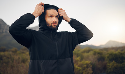 Image showing Hiking man, nature and morning fitness for freedom, running and exercise in mountains, adventure and wellness. Focus mindset of thinking runner with hoodie for cold, calm and healthy training workout