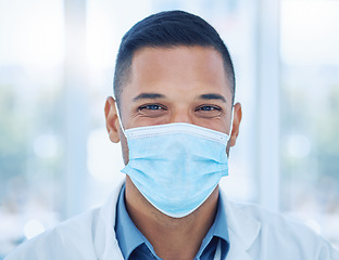 Image showing Covid, face mask and portrait of a happy doctor in a hospital working, smiling and helping with healthcare expertise. Smile, compliance and medical worker with coronavirus safety protection in India