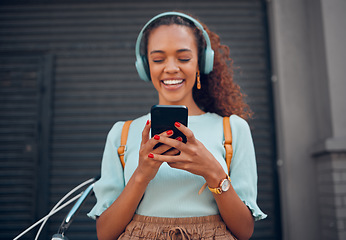 Image showing Phone, music and social media with a black woman streaming audio through a subscription service in the city. Travel, communication and text message with a young female networking in an urban town