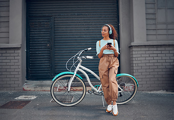 Image showing Phone, bike and city travel for woman with music headphones, podcast or radio in London city. Thinking fashion student, mobile or cool model with eco friendly and future environment energy transport