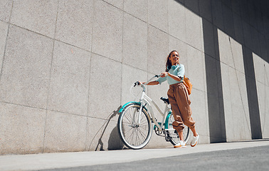 Image showing Bike, urban and black woman cycling in the city of Norway for a sustainable lifestyle. Happy, young and smile African girl with a bicycle being eco friendly for her carbon footprint and clean energy