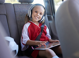 Image showing Soccer, car and girl with tablet for music traveling to football practice, exercise and childrens fitness workout. Smile, sports and happy kid in headphones enjoys drive trip to training on a weekend