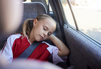 Image showing Soccer, travel and girl sleeping in a car tired from sports practice, training and fitness workout for children. Transportation, relaxing and young kid resting and dreaming peacefully after football