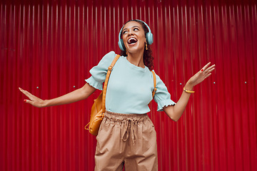 Image showing Happy woman streaming music, singing and hip hop dance on stage with headphones. Young musical performer, fun and energy in trendy fashion .....broadway.solo act.dancing.listen to music.hip hop rmb