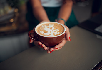 Image showing Coffee, art and design with hands of woman in cafe for creative, breakfast and latte. Foam, milk and service with barista and cappuccino at countertop in coffee shop for drink, morning and lifestyle