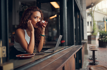 Image showing Young woman, content and drink coffee at cafe for relax, peaceful and focused on work with laptop. Female, girl and hot beverage or tea in hand take a break, for lunch and thinking in coffee shop.