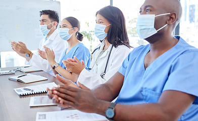 Image showing Covid face mask, clapping and medical presentation for doctors, nurses or London hospital healthcare teamwork. Men, women and medicine team applause in seminar meeting for covid 19 compliance success