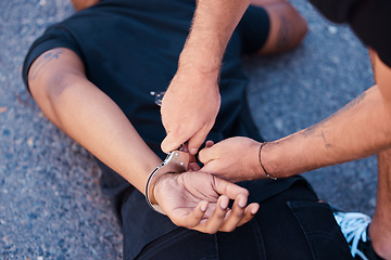 Image showing Hands, handcuffs and man on floor with police agent, justice and human rights in Iran to stop protest. Crime, law and freedom in arrest in street, criminal or thief arrested in city by police officer