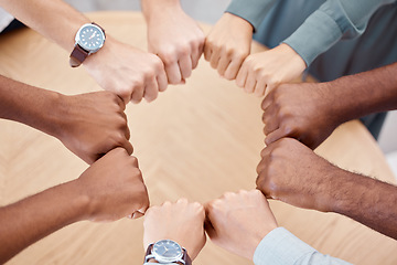 Image showing Circle, fist and diversity for solidarity, above and teamwork in office for power, unity and collaboration at table. Group, job and hands in workforce, team and staff for goal, motivation or mission