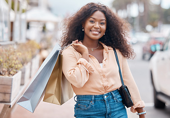 Image showing Black woman, shopping and bags with smile in the city for sale, discount and urban outdoors. Portrait of happy African American female shopper holding gifts smiling in happiness for town market