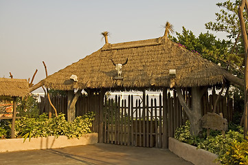 Image showing Gated entrance with thatch roof