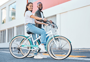 Image showing Happy couple, bicycle and city street travel for exercise, fun or adventure outdoor. Black and asian tourist man and woman cycling for carbon footprint on bike in urban town traveling in South Africa
