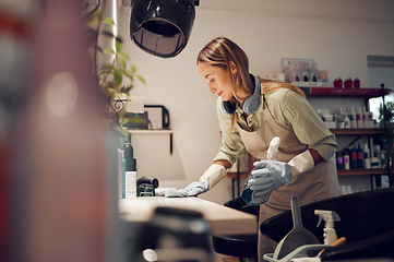 Image showing Hair salon, cleaner and woman cleaning a workplace in Australia with equipment to disinfect. Housekeeper, maid or girl dusting table with hygiene, detergent and sanitizing products in beauty parlor