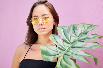 Image showing Fashion sunglasses, asian and woman with leaf calm, relax and confident in her retro, vintage and yellow summer glasses. Beauty, skin and face portrait of chic gen z girl on Singapore travel vacation
