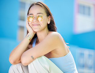 Image showing Fashion sunglasses, asian and woman relax in urban city street for peace, freedom or Singapore vacation. Portrait of happy gen z girl on holiday with chic clothes, retro and vintage yellow glasses