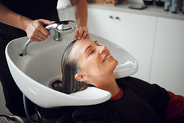 Image showing Woman, salon and hair care in wash treatment for beauty, luxury and relax with smile indoors. Happy female enjoying calm relaxation smiling in happiness for clean, service and style by hairdresser