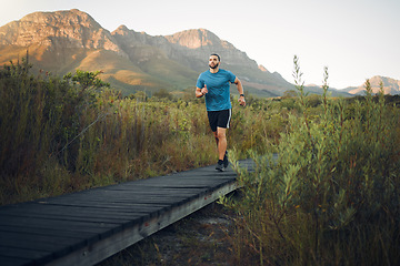 Image showing Fitness, countryside or man running on path for sports exercise, marathon training or cardio workout for healthy body. Wellness lifestyle, mountain freedom or nature peace runner on calm morning run