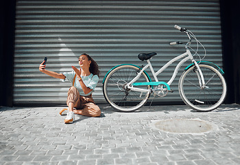 Image showing Bicycle, street and woman taking a selfie in a city blowing a kiss in photo or pictures in summer outdoors. Freedom, bike and young girl creating phone content for social media followers in holidays